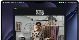 A video call on a MacBook Pro where a woman shows fabrics to two people on the call, with Center Stage keeping her centered in the frame as she moves around