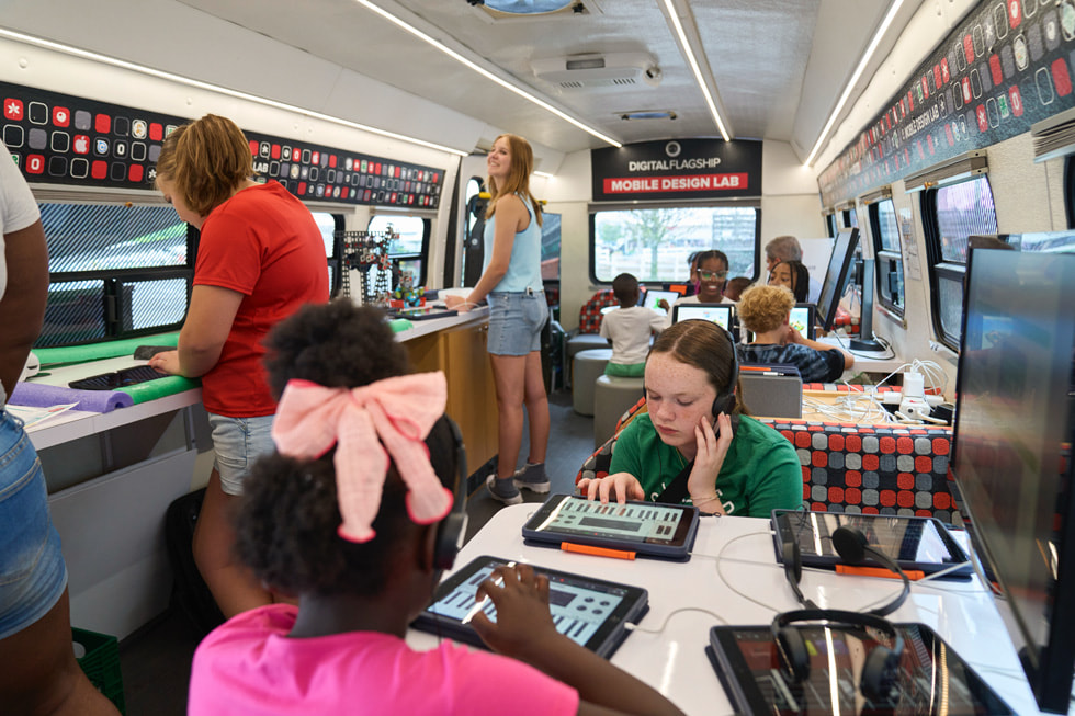 4-H club members using Apple Pencil in GarageBand on iPad inside the mobile classroom bus.