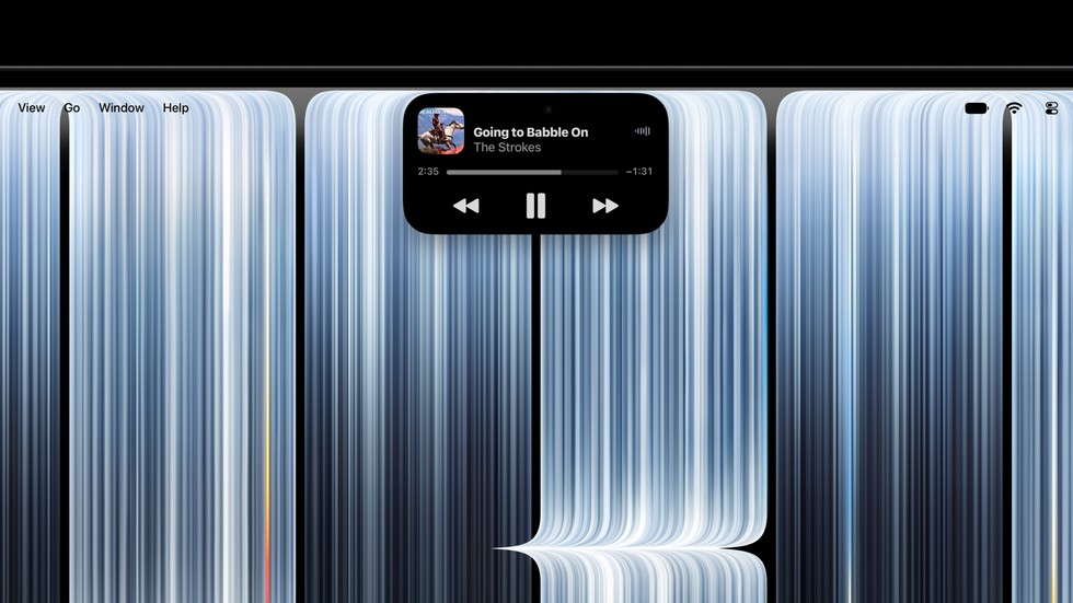 A close-up of the Dynamic Island on a user’s MacBook Pro with PROLED XDR Display shows a song playing in Apple Music.