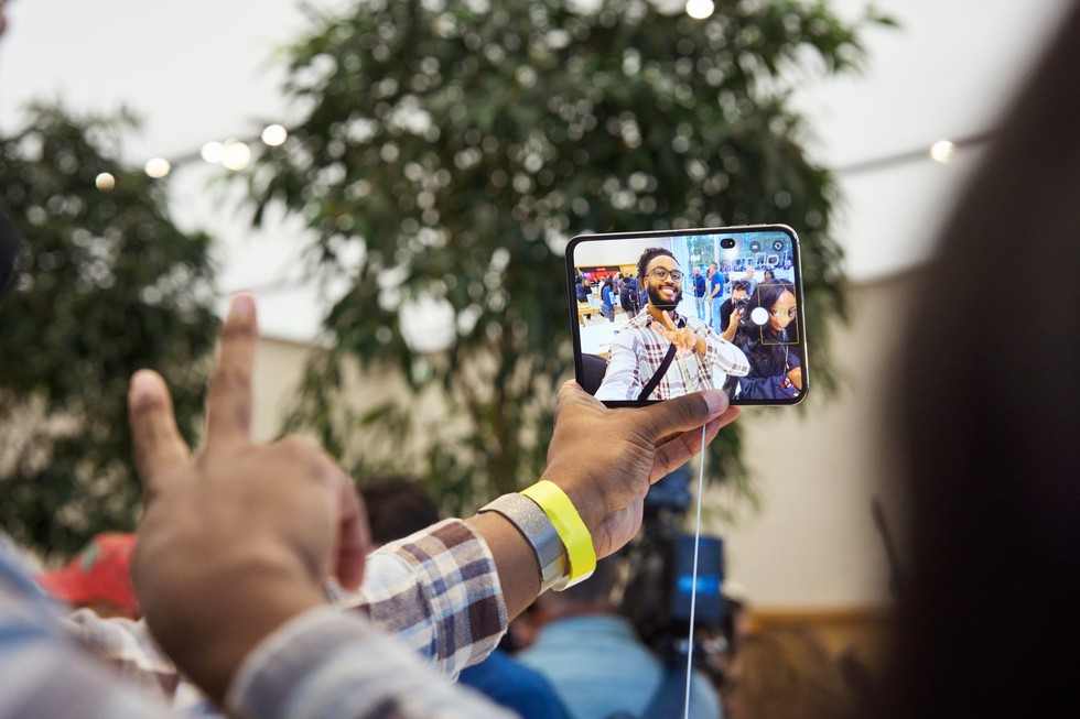 A customer at Apple Domain NORTHSIDE takes a selfie with iPhone Duo.