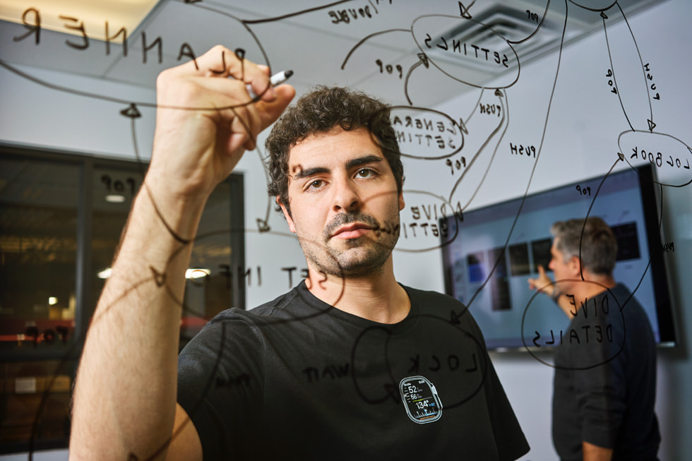 Niccolò Consolazio writes on a clear whiteboard.