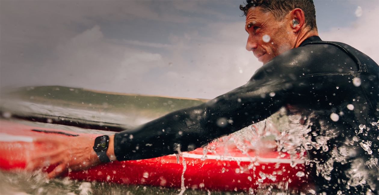 A man surfing with Apple Watch.