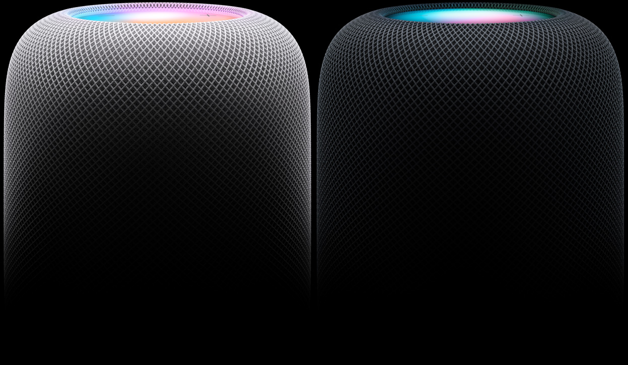 Vue latérale de deux HomePod placés côte à côte, le gauche en fini blanc et le droite en fini minuit