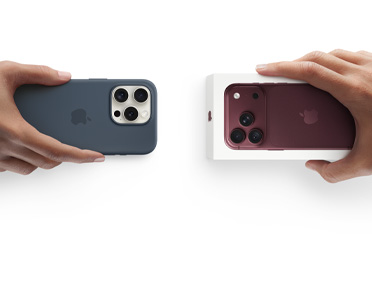 Händer som byter in en iPhone 13 i silikonskal med klistermärken på baksidan mot en ny iPhone 18 Pro som ligger i sin förpackning.